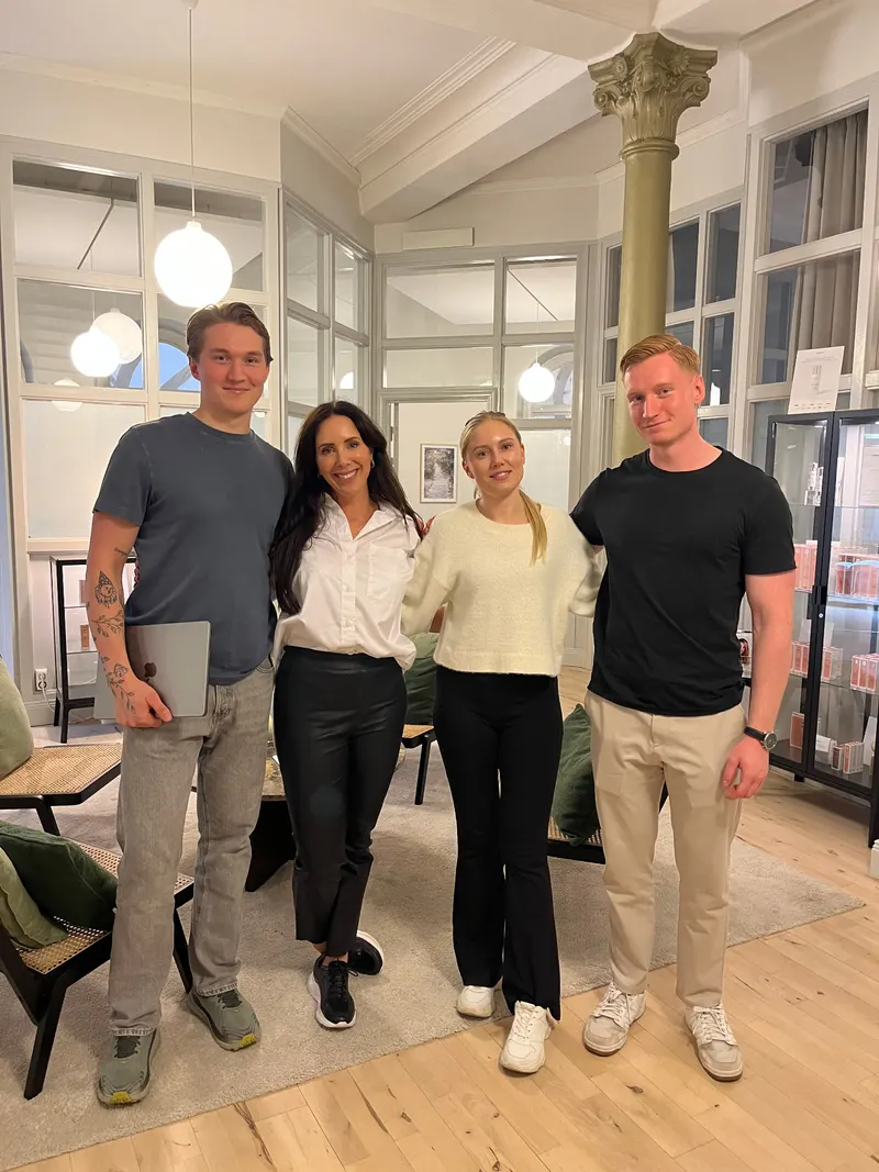 The Glow team with a client in their clinic lounge